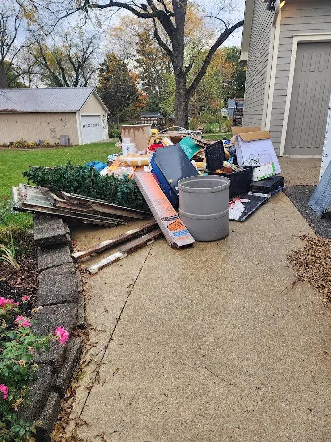 Dumpster being loaded with debris for Roofing Dumpster Rental in Lake Delton